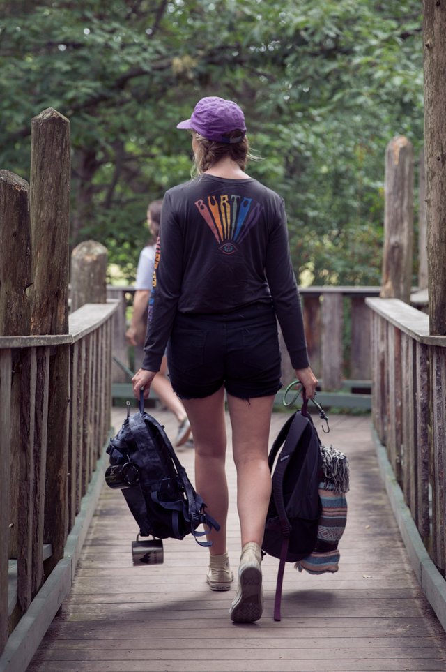 Burton employee holding two backpacks