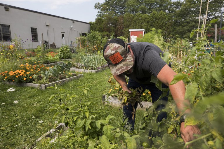 Burton employee tending to his garden