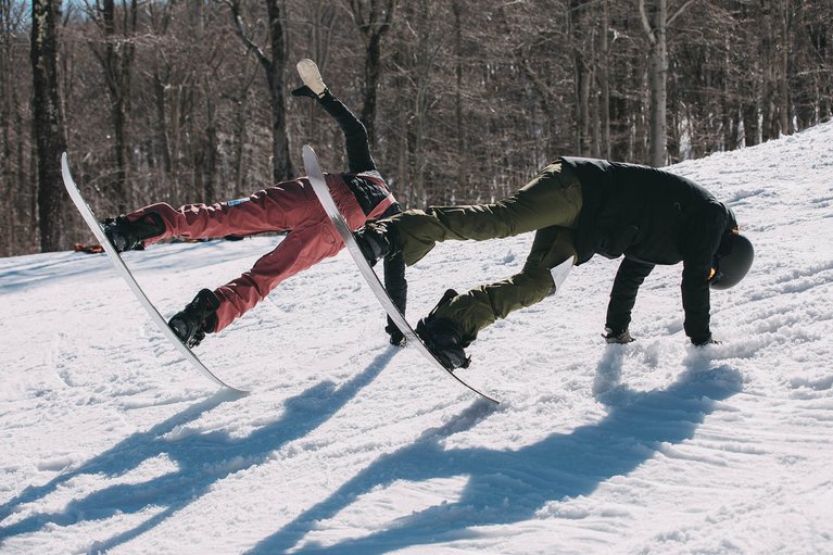 Two women doing tripods