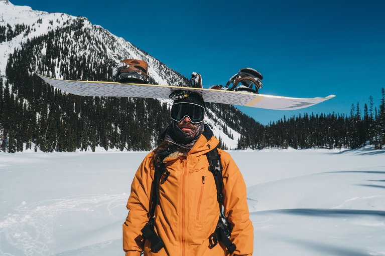 Danny Davis with the Deep Thinker snowboard balanced on his head.