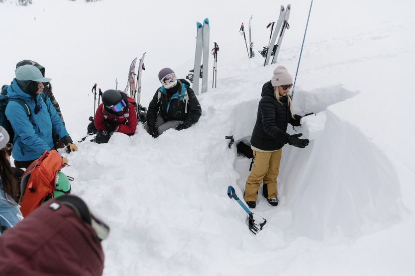 Kate showing the layers of snow.